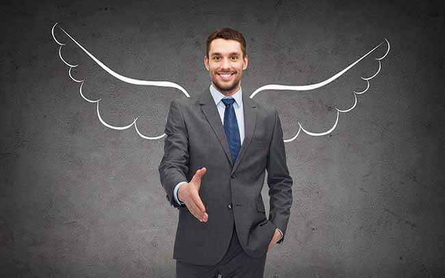 happy businessman with angel wings over gray