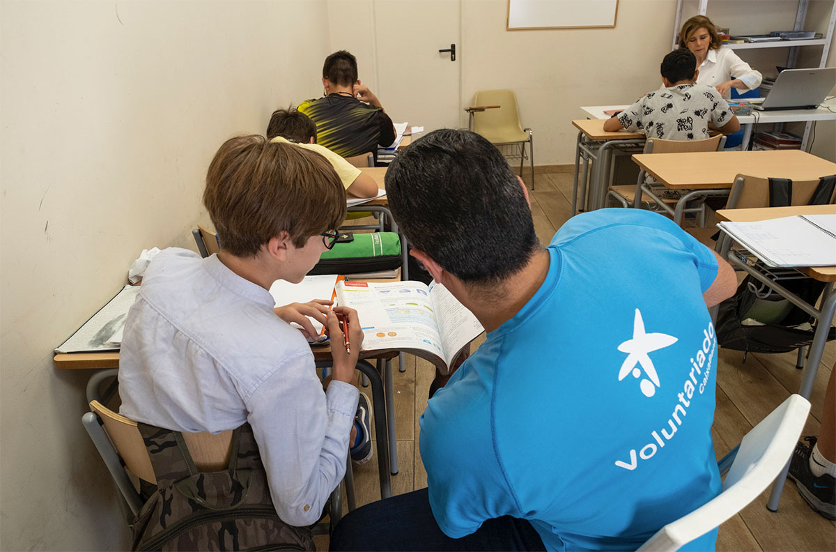 voluntarios de caixabank ayudando a reforzar la lectura en los colegios